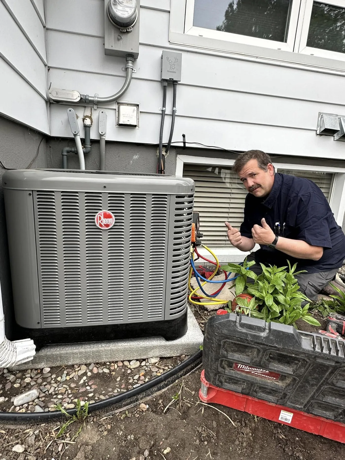 Reid Pro crew giving a thumbs up beside a finished AC install