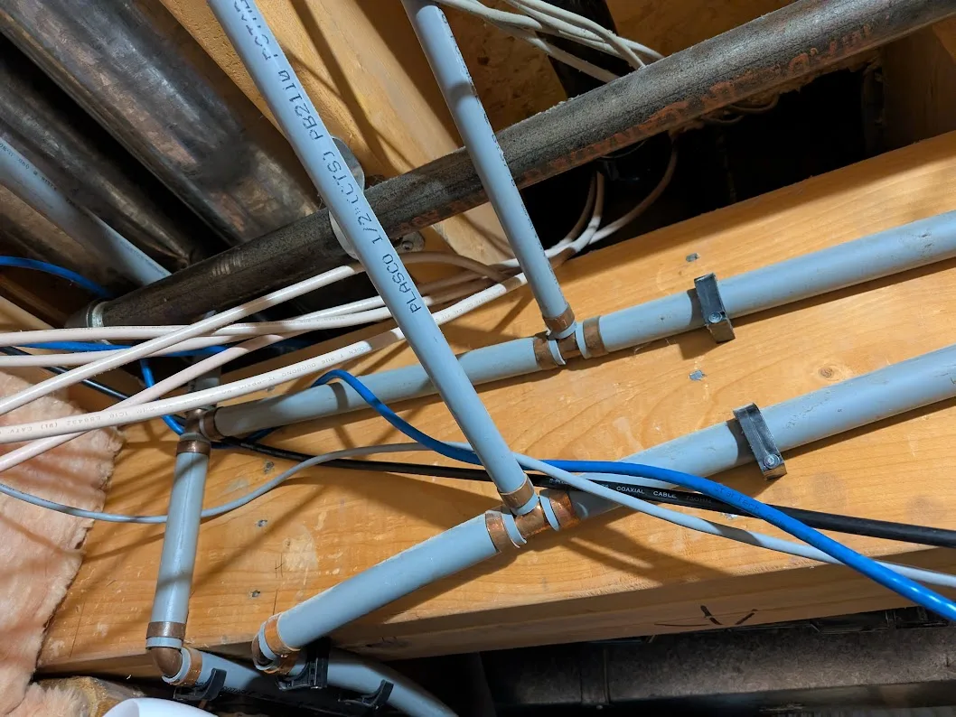 Grey Poly B water piping ready for replacement with new PEX